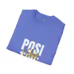 Periwinkle blue t-shirt folded to display 'POSITIVE VIBES' graphic in white and gold lettering on front, with brand label visible at neckline, against white background