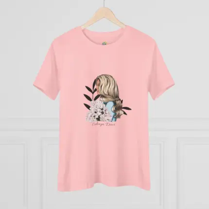 Light pink short-sleeve crew neck t-shirt displayed on a wooden hanger against a white paneled wall, featuring a centered graphic illustration of a woman with long blonde wavy hair viewed from behind, adorned with white hydrangea flowers and black decorative leaves, with 'Always Down' script text beneath the design